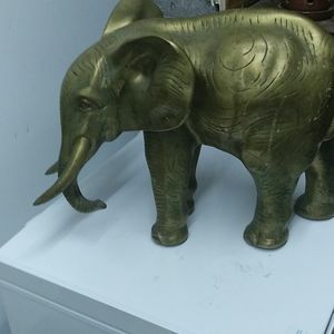 Antique brass elephant with trunk down